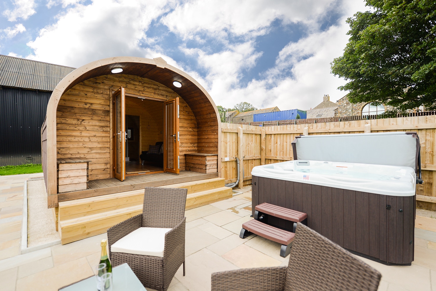 An open glamping pod with a private hot tub